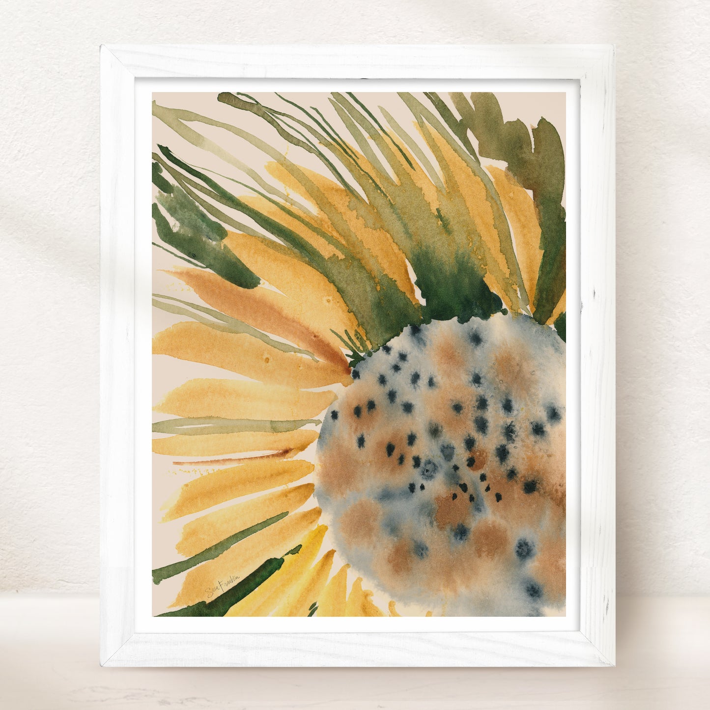 The image is a framed watercolor painting depicting a vibrant sunflower with yellow petals and green leaves.