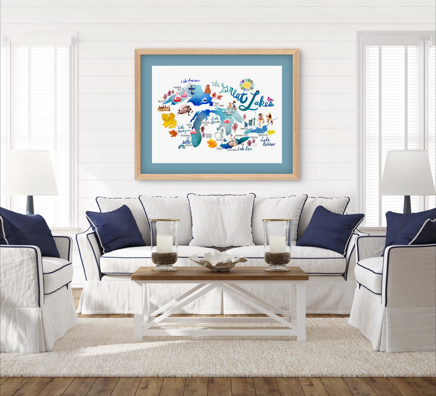 a living room with white furniture and blue accents
