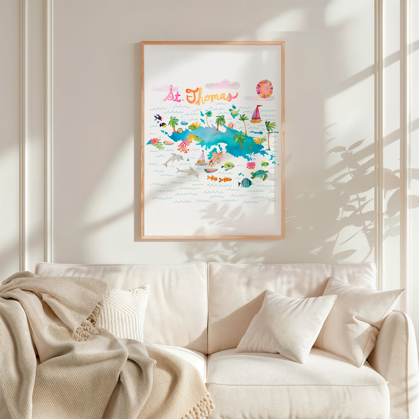 a living room with a white couch and a white blanket
