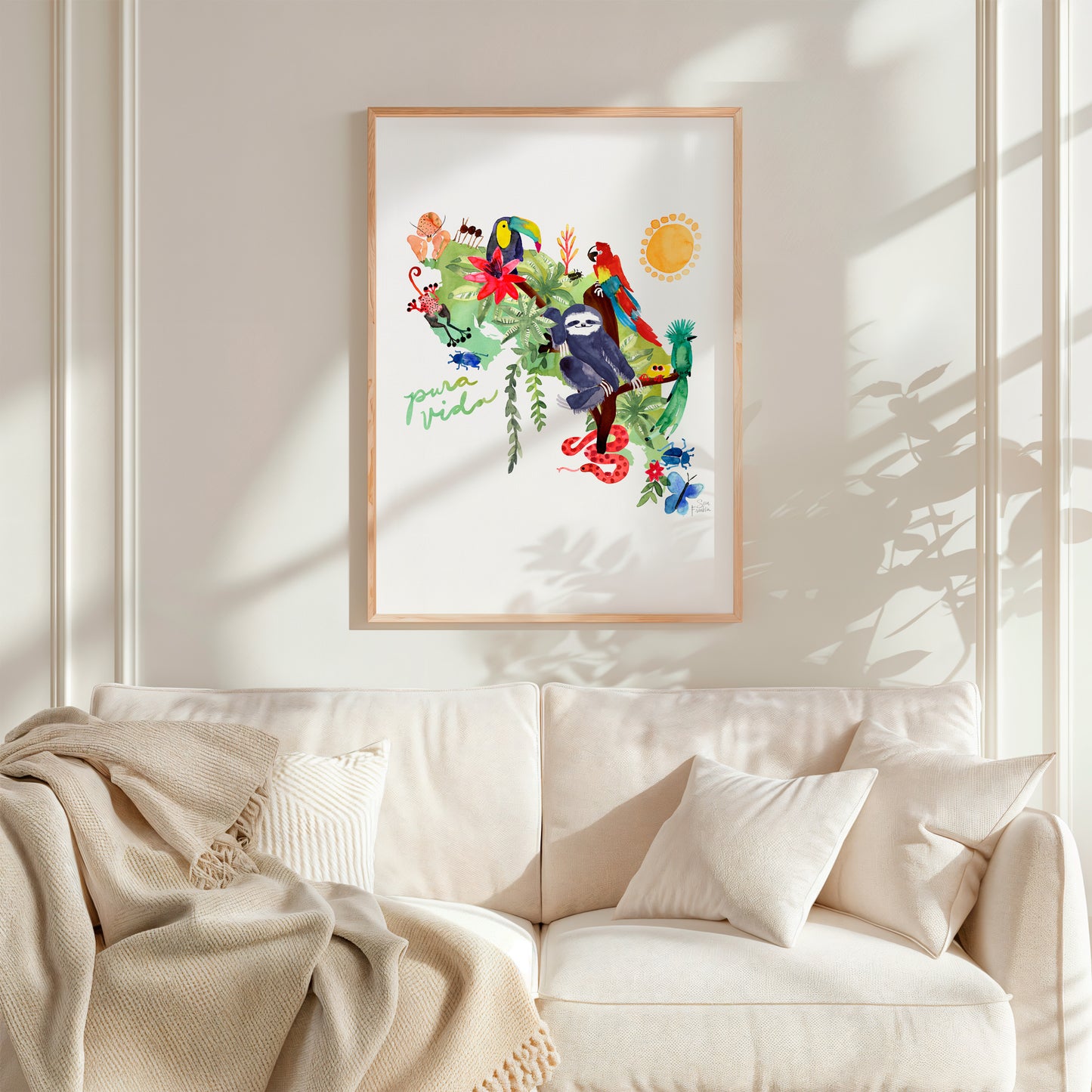 a living room with a couch and a painting on the wall