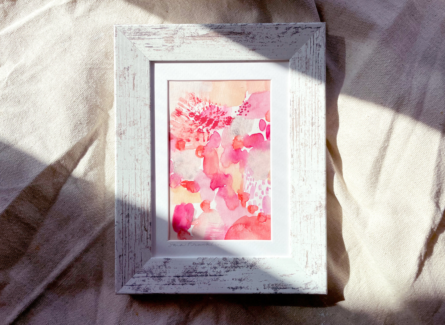 a picture frame sitting on top of a bed