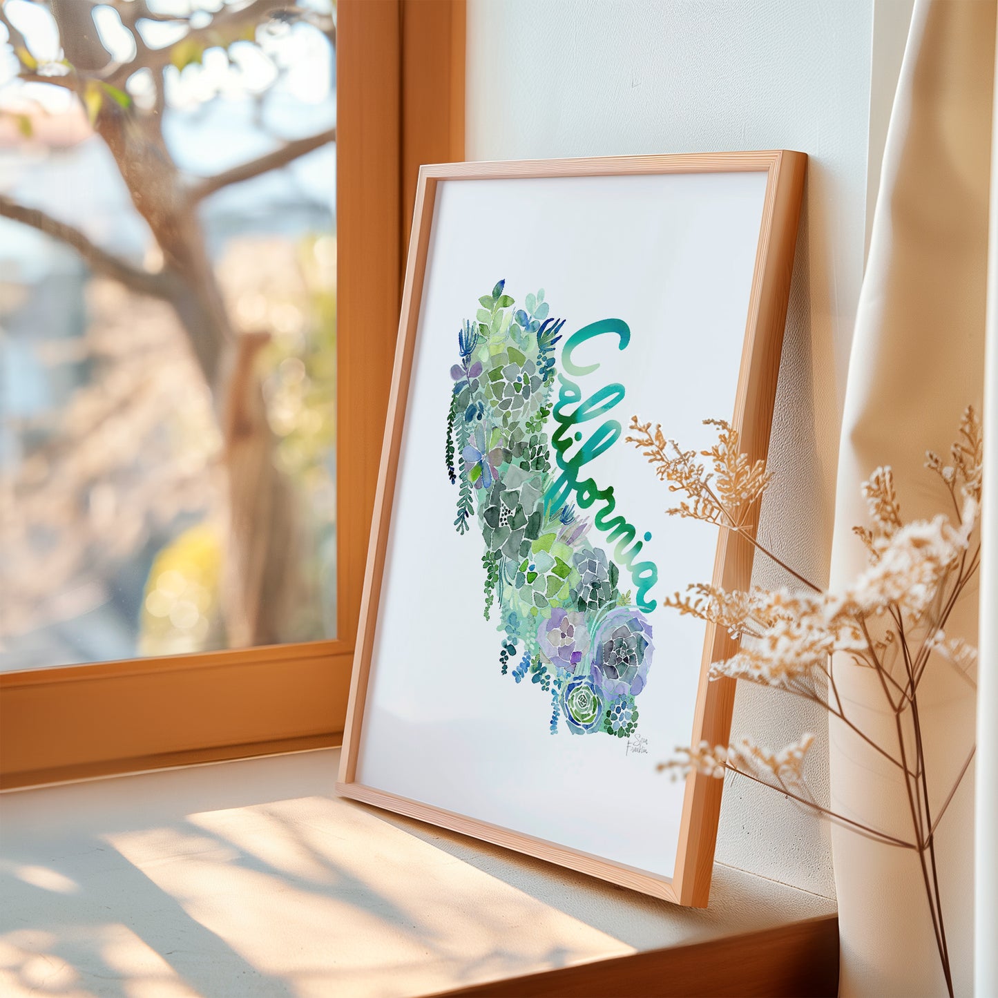 a picture frame sitting on a window sill next to a window