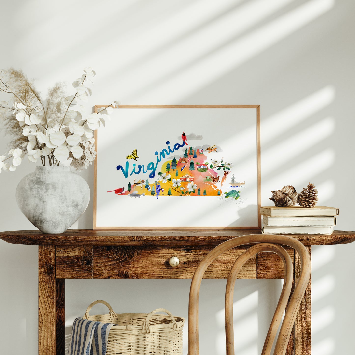 a wooden table with a vase of flowers and a picture