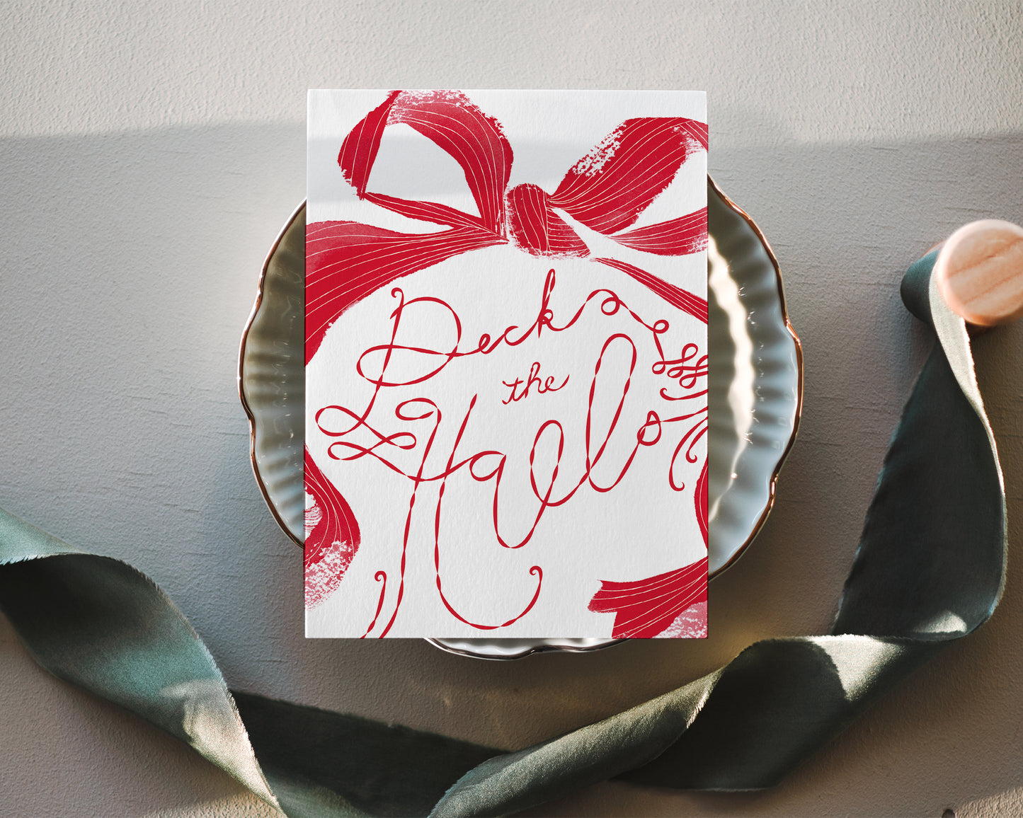 a paper plate with a red bow on it