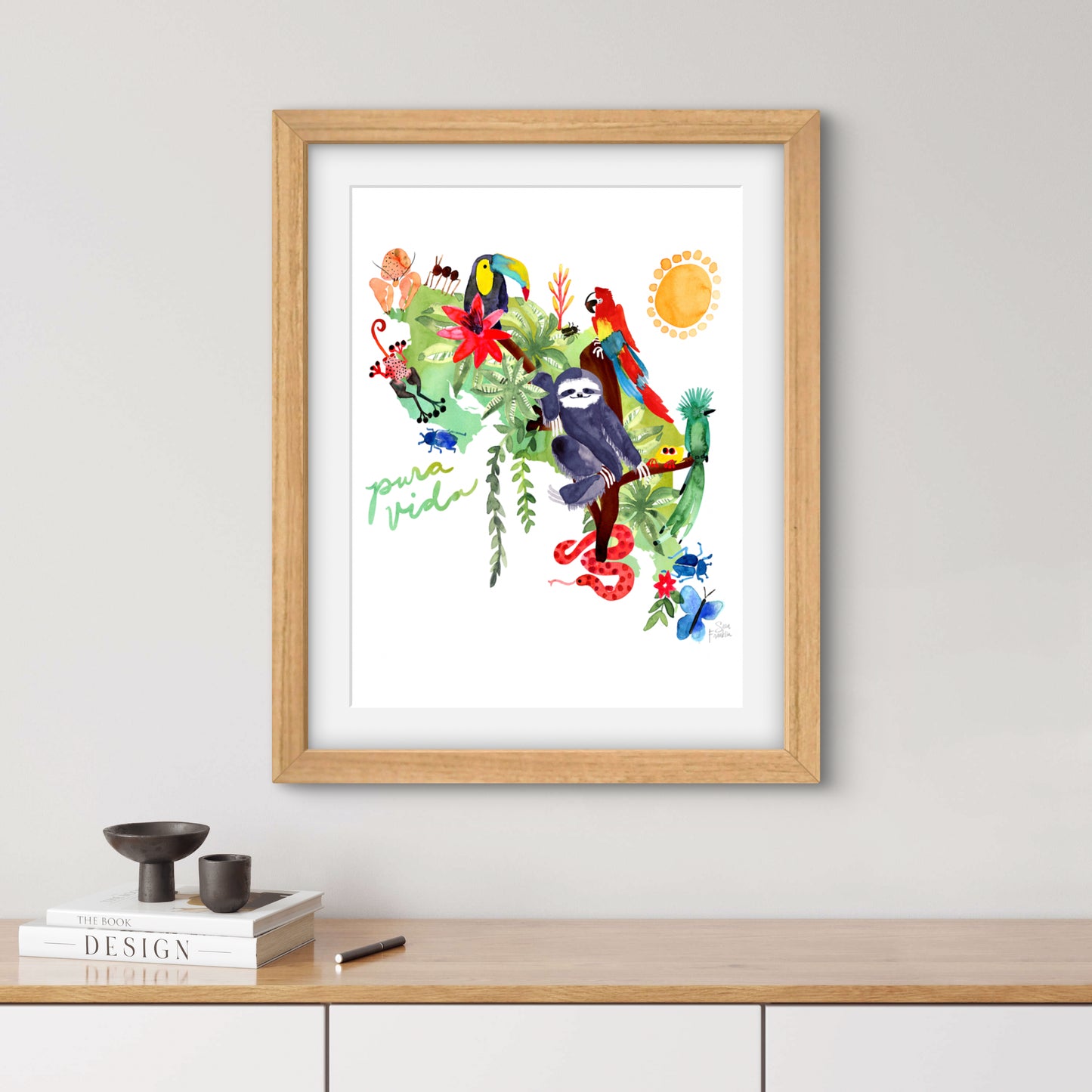 a framed picture of a monkey and tropical plants