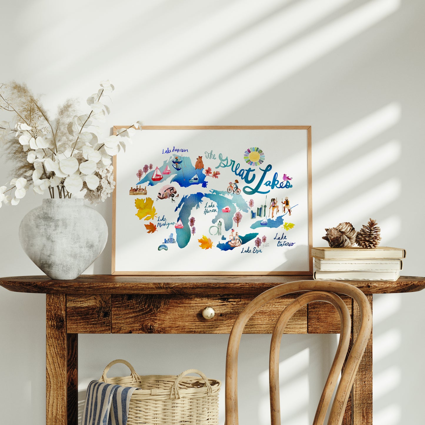 a wooden table topped with a white vase filled with flowers