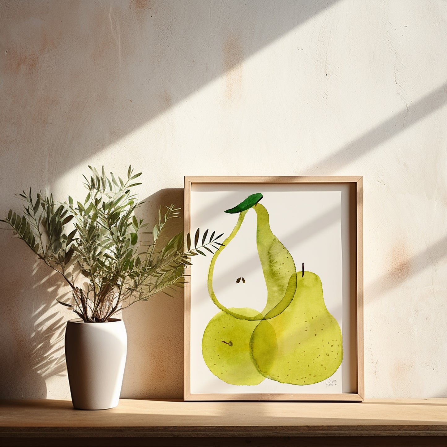 a white vase with a plant on a shelf, next to a framed painting of two green pears.