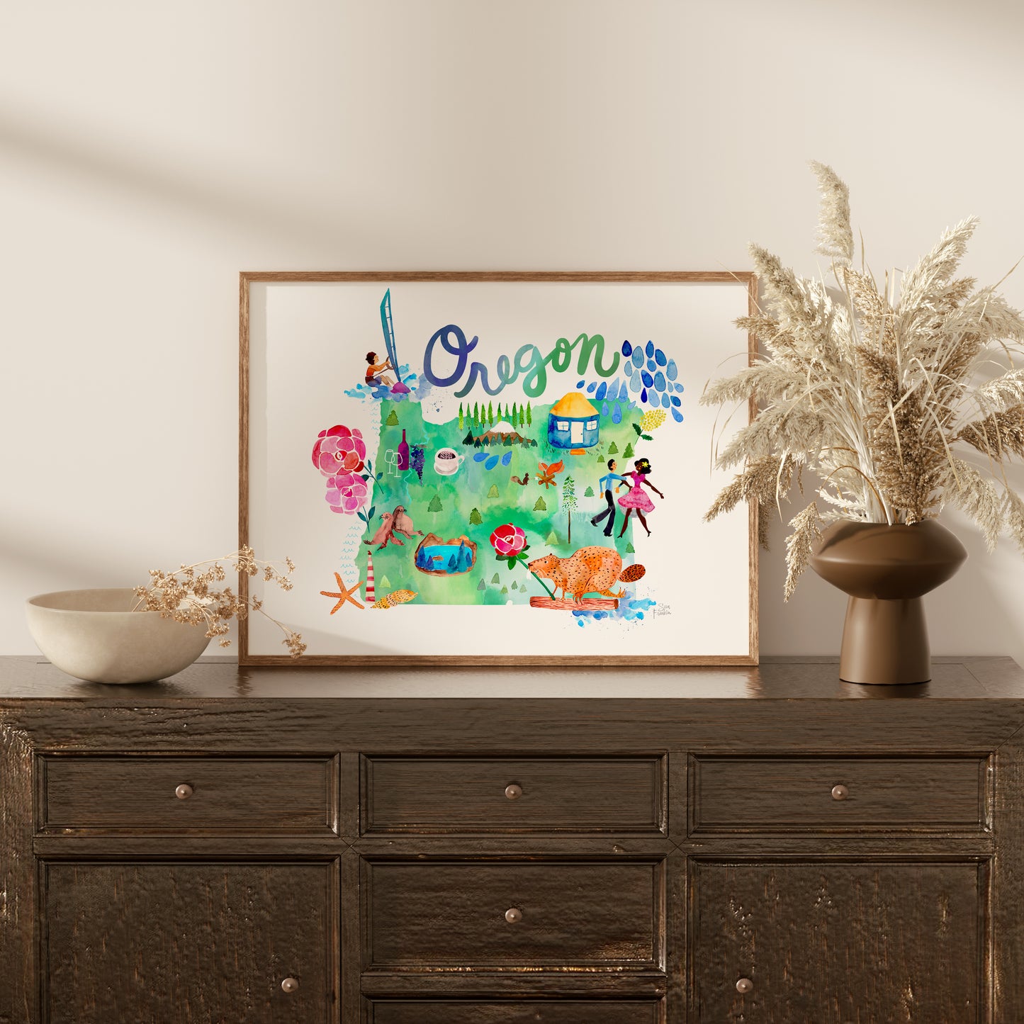 a wooden dresser with a vase and a painting on top of it