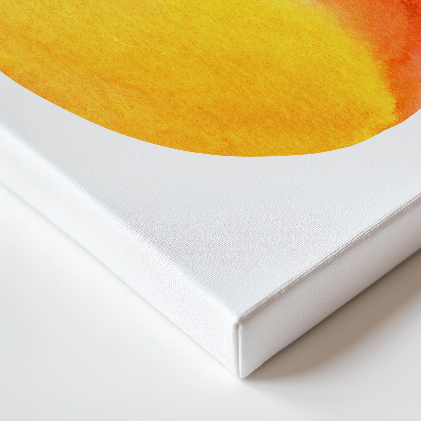 The image is a close-up of a white canvas or frame with a vibrant yellow and orange watercolor painting or print on it.