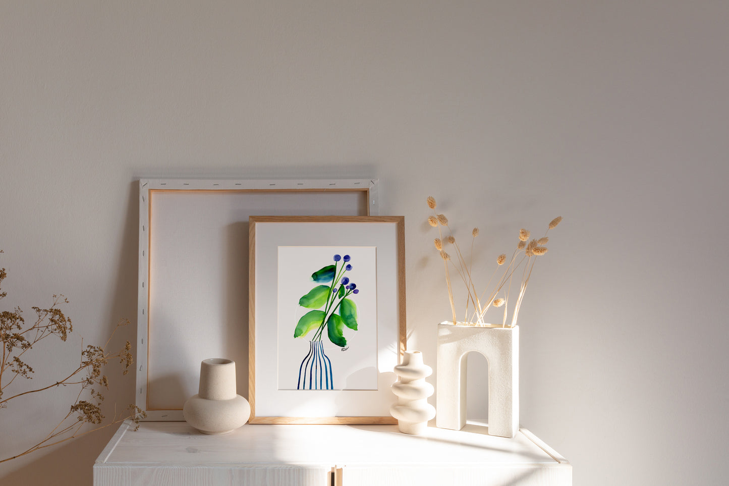 a picture of a plant and vases on a mantle