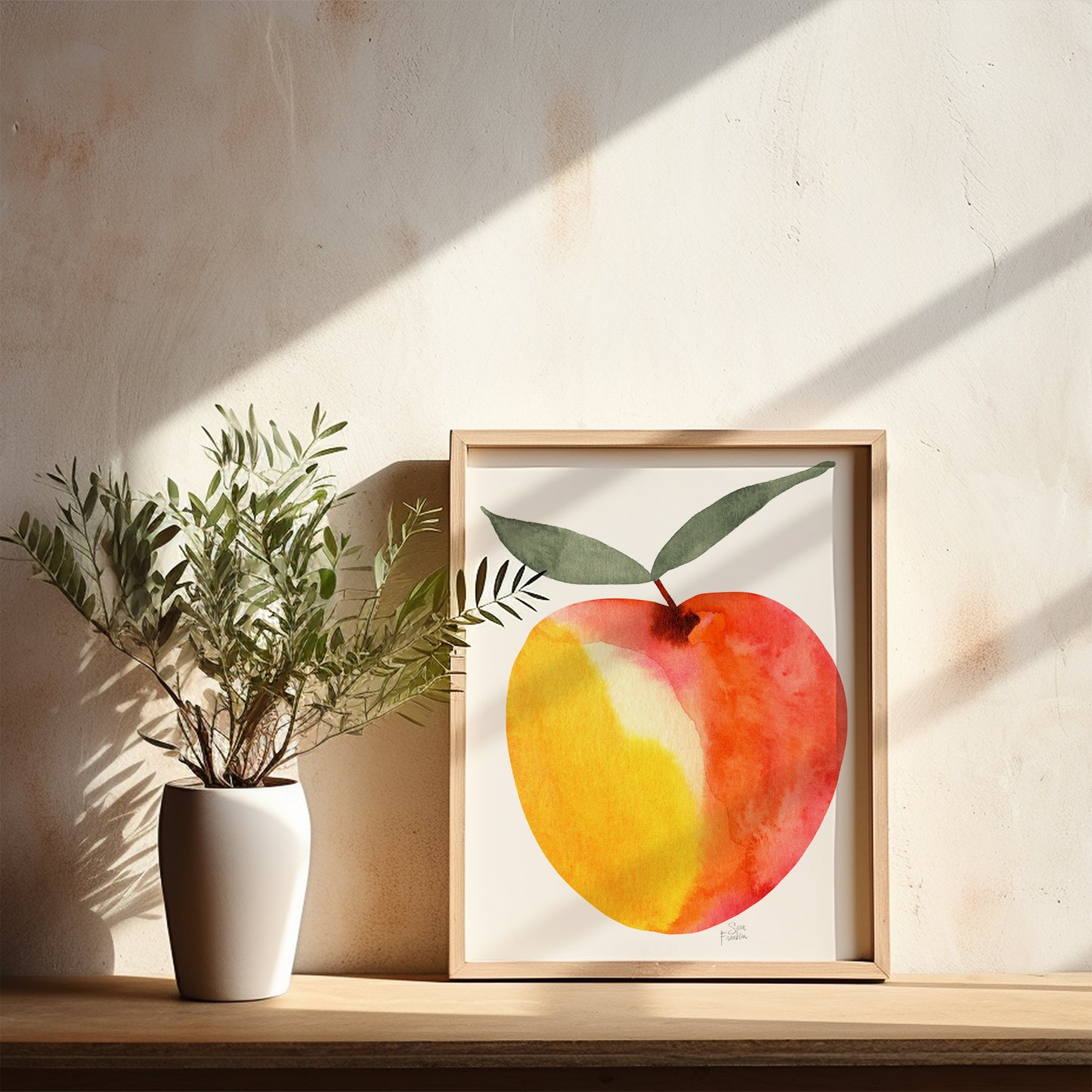 a white vase with a plant on a shelf, and a framed painting of a watercolor apple with a green leaf on a white wall.
