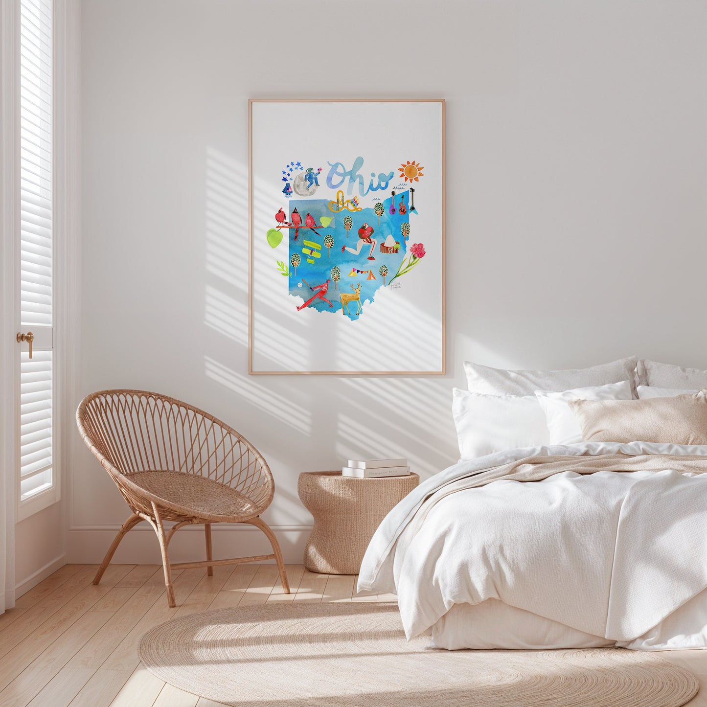 a bedroom with a bed, chair and a picture on the wall