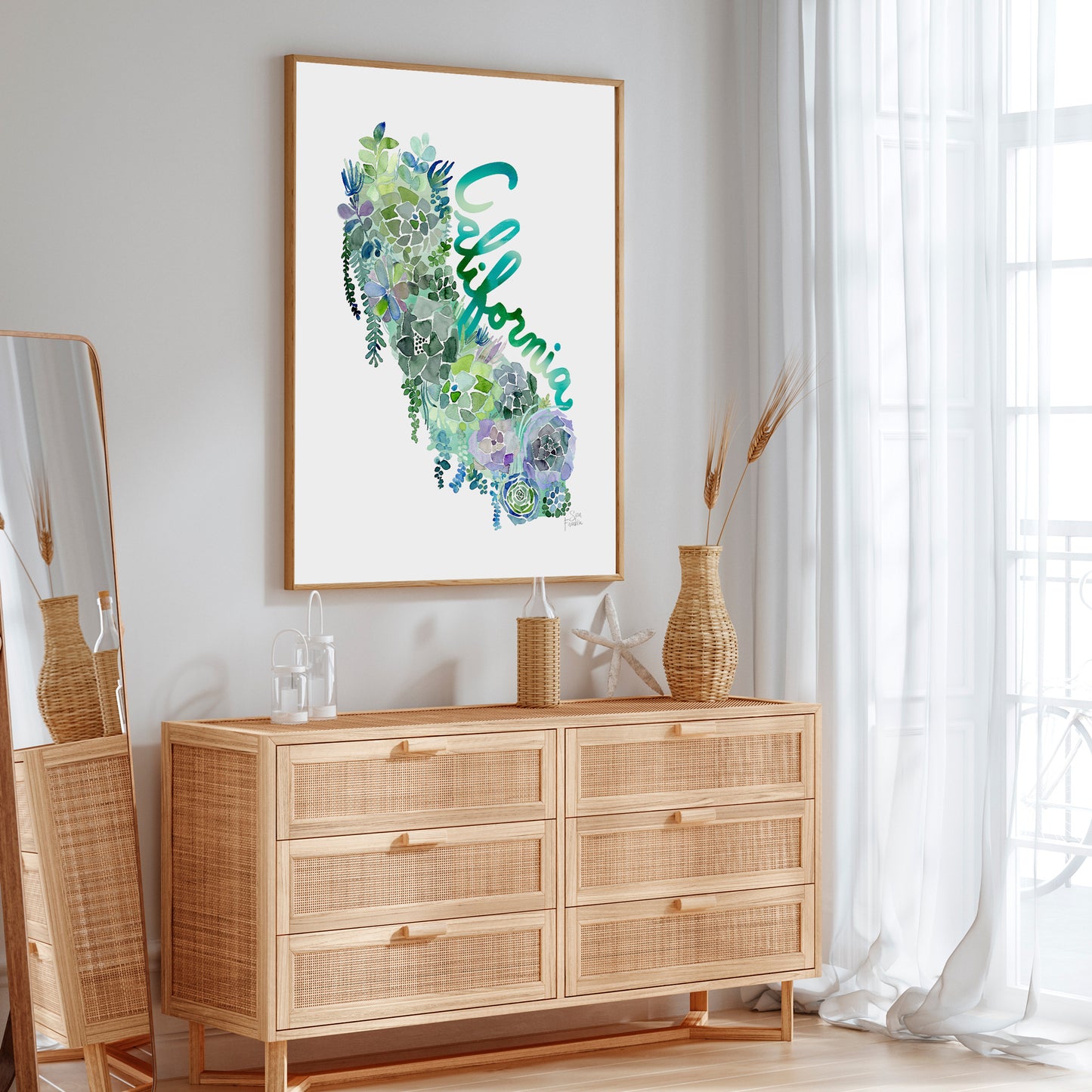 a picture hanging on a wall above a dresser