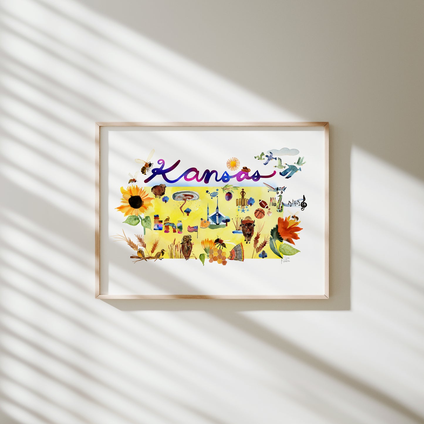 a picture hanging on a wall with a shadow of a sunflower