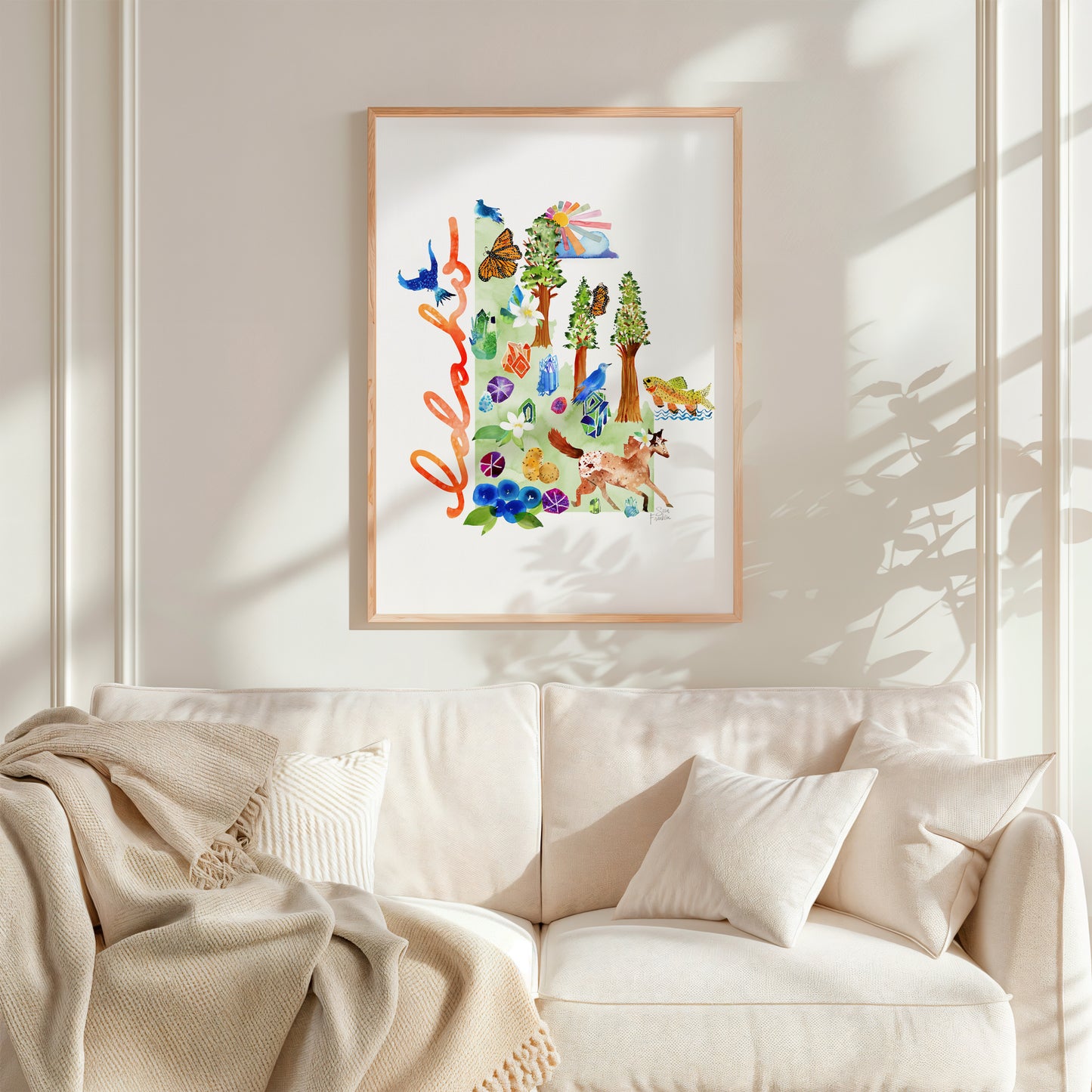 a living room with a white couch and a painting on the wall