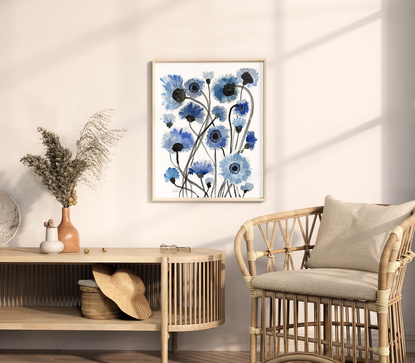 a living room with a wicker chair and a painting on the wall