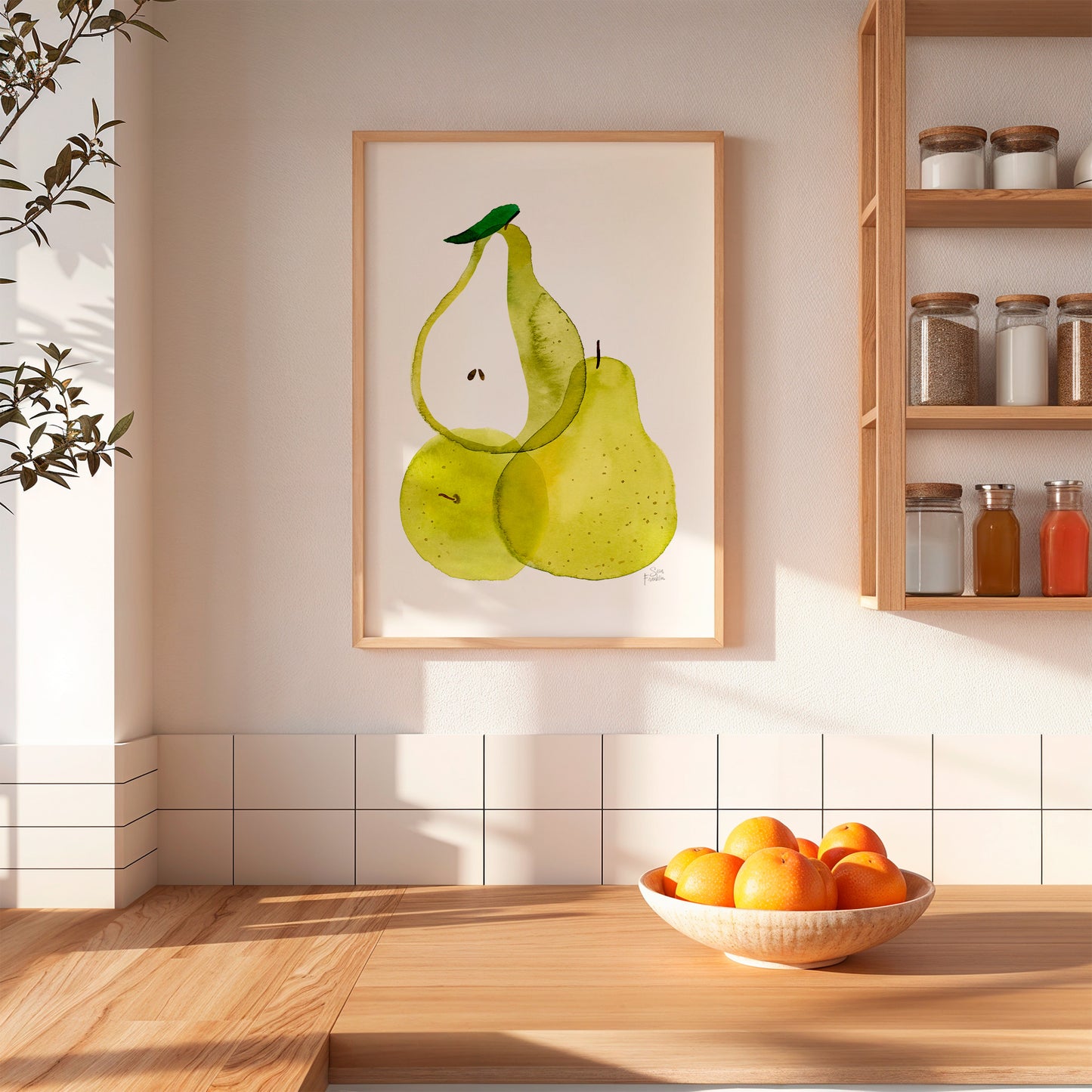 a kitchen scene with a framed painting of two green pears hanging on the wall above a wooden table. On the table, there is a bowl of oranges.