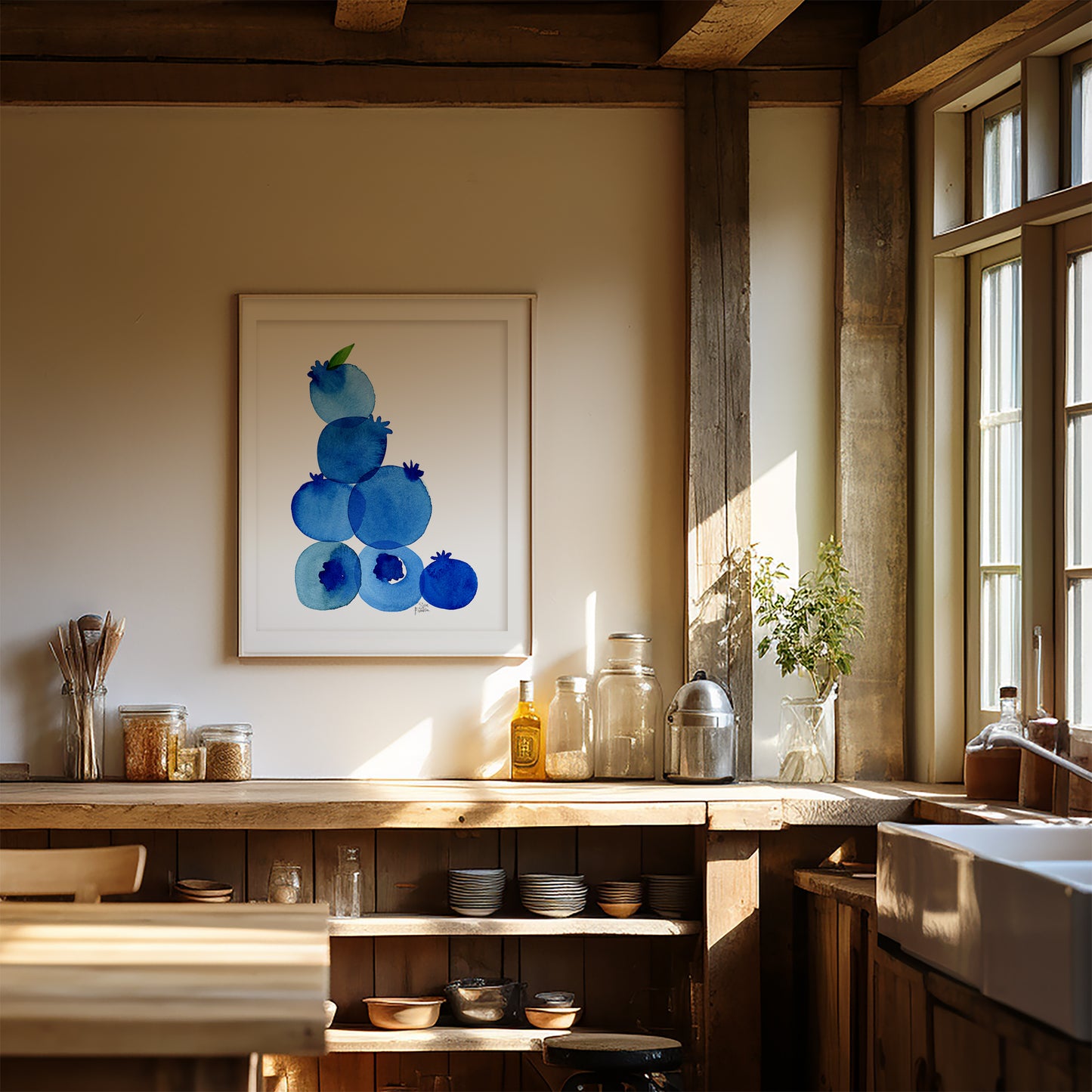 a cozy kitchen with a wooden counter, a sink, and various kitchen items such as jars, bottles, and bowls. A framed artwork of blueberries hangs on the wall above the counter, adding a touch of color and nature to the space.