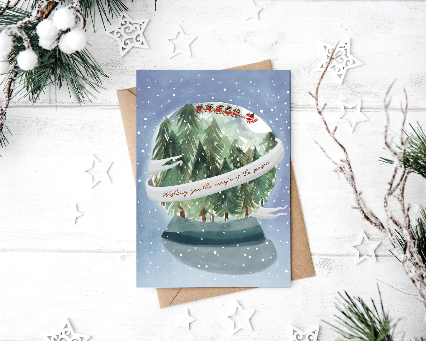 a christmas card with a picture of a snow globe