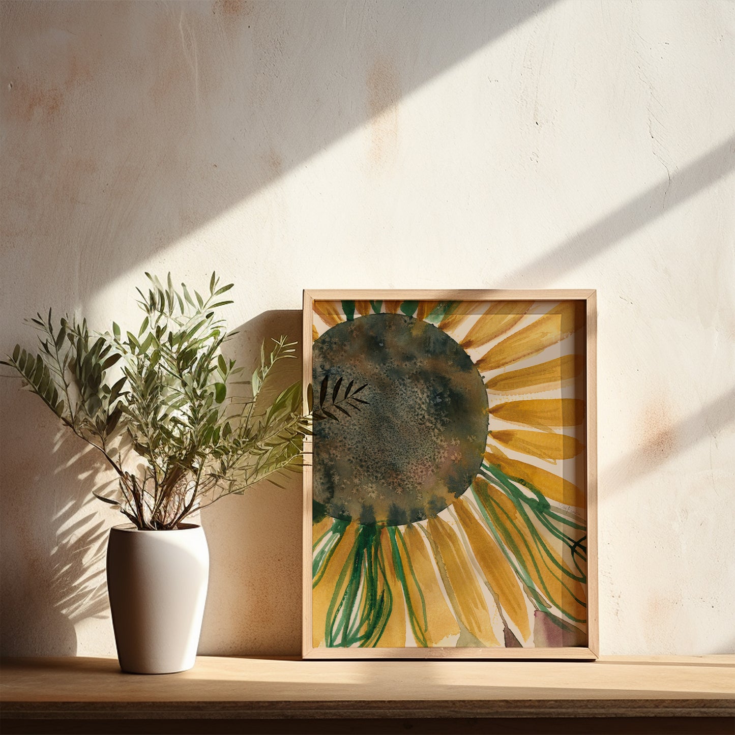 a white vase with a plant on a wooden shelf, accompanied by a framed painting of a sunflower.