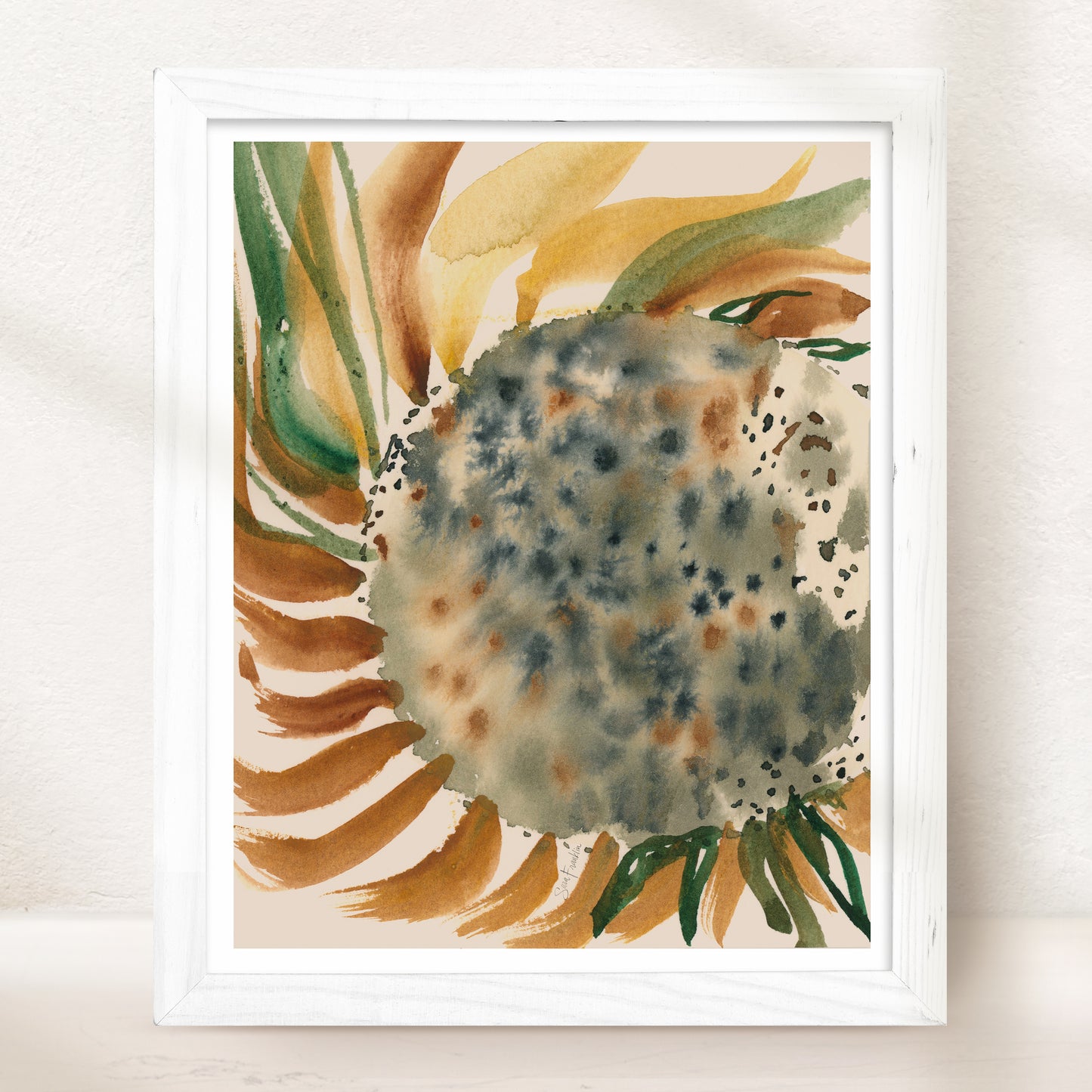 The image is a framed watercolor painting depicting a sunflower with a mix of green, brown, and orange hues.