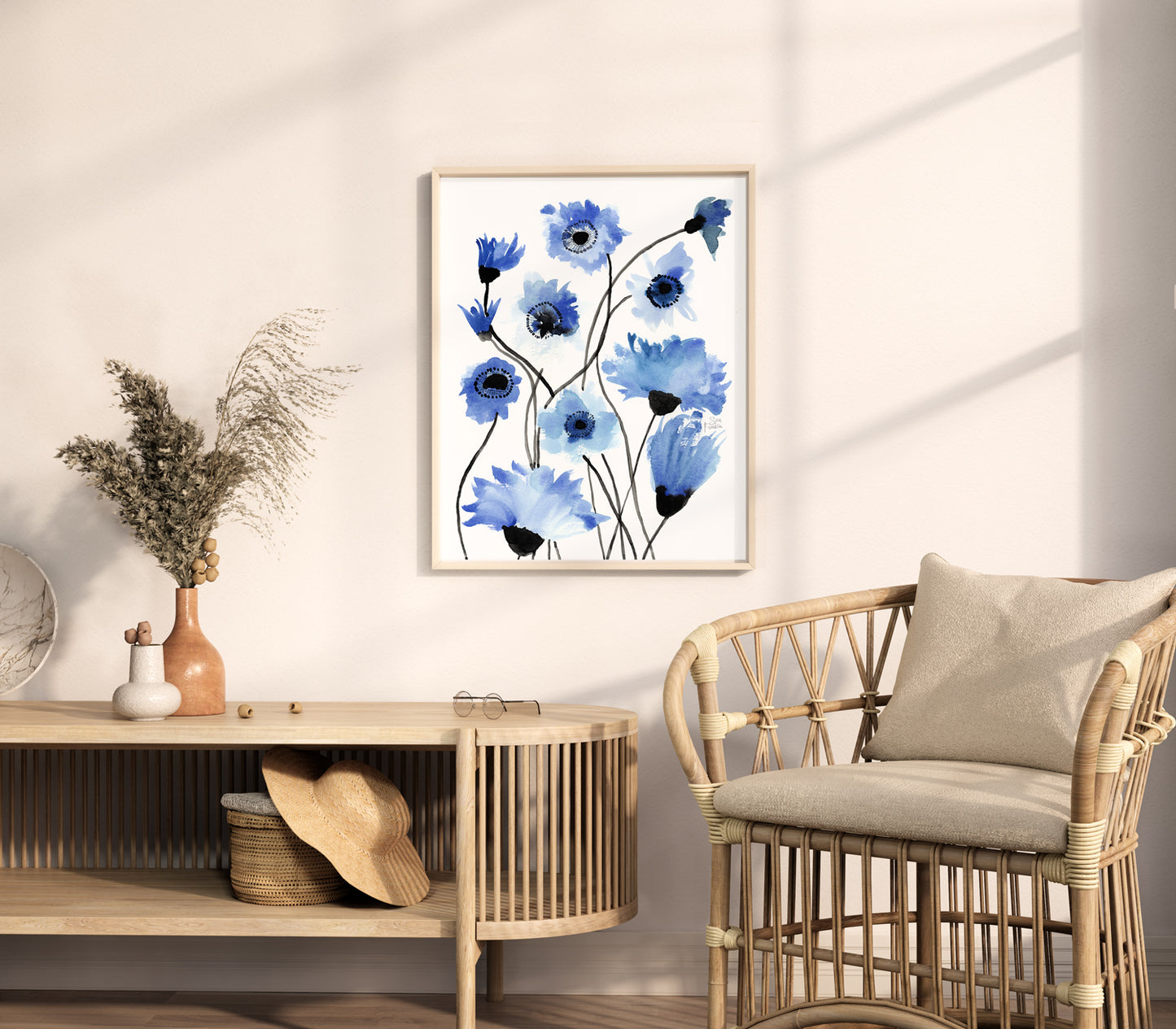 a living room with a wicker chair and a painting on the wall