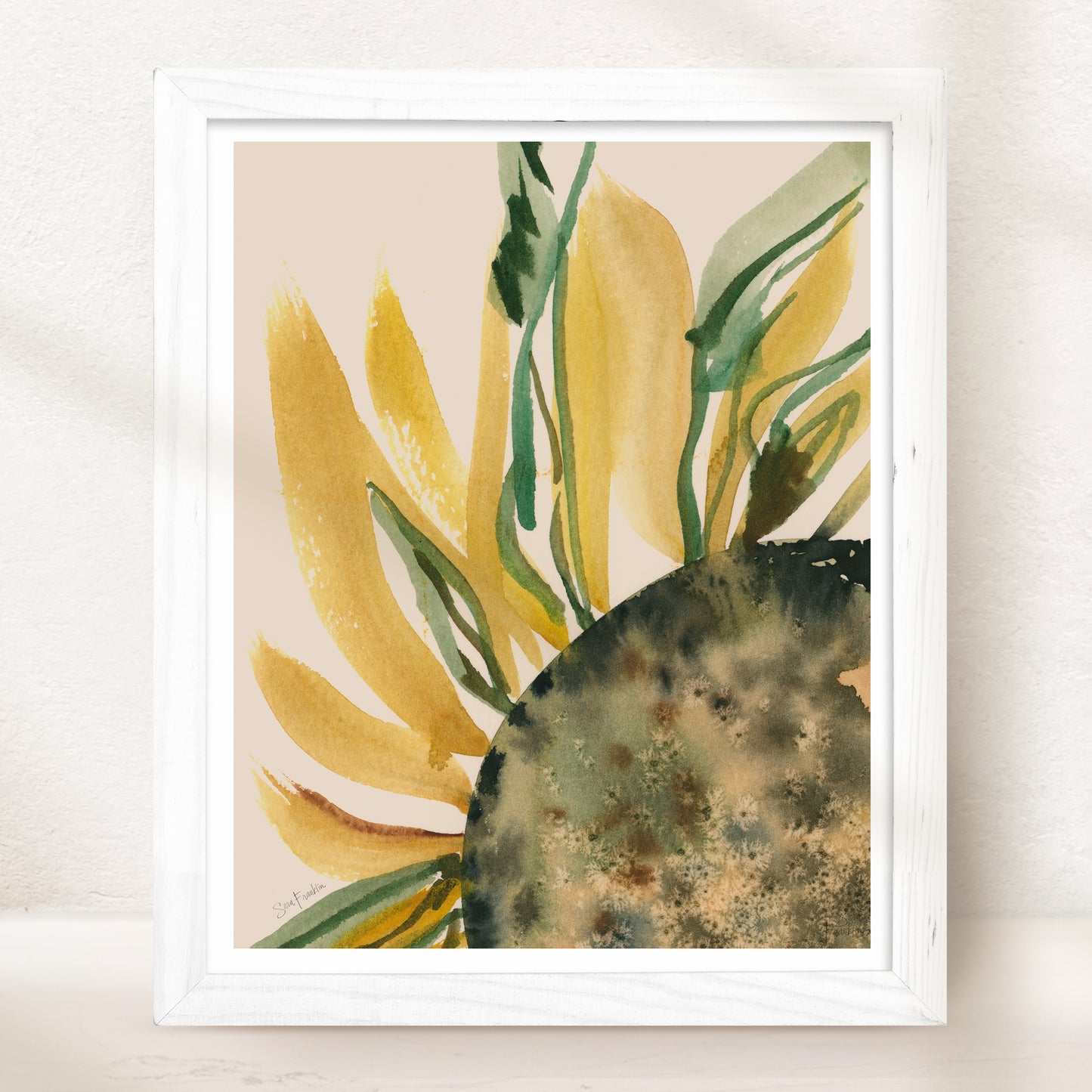 The image is a framed watercolor painting depicting a vibrant sunflower with yellow petals and green leaves.