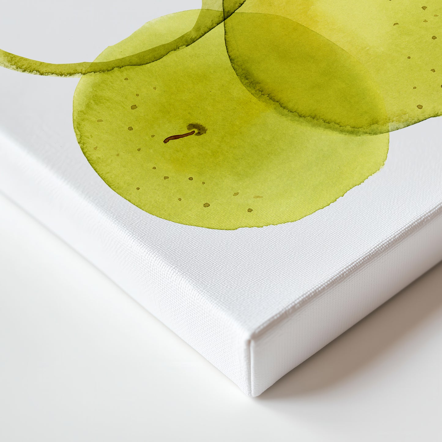 a close-up view of a green apple with a stem, set against a white background.