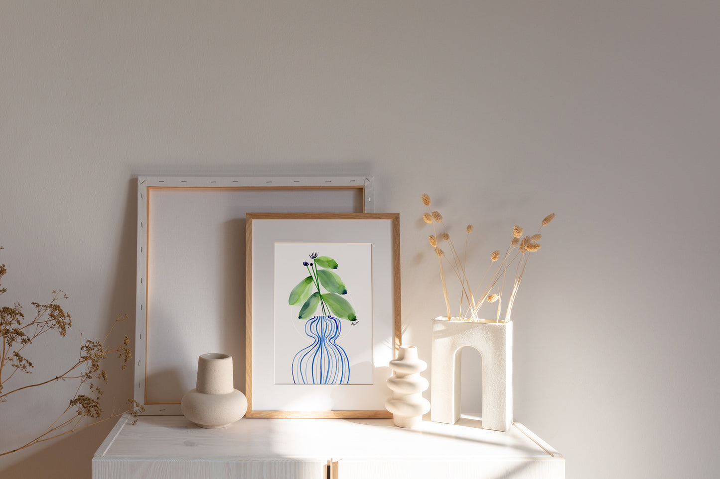 a picture of a plant and vases on a mantle