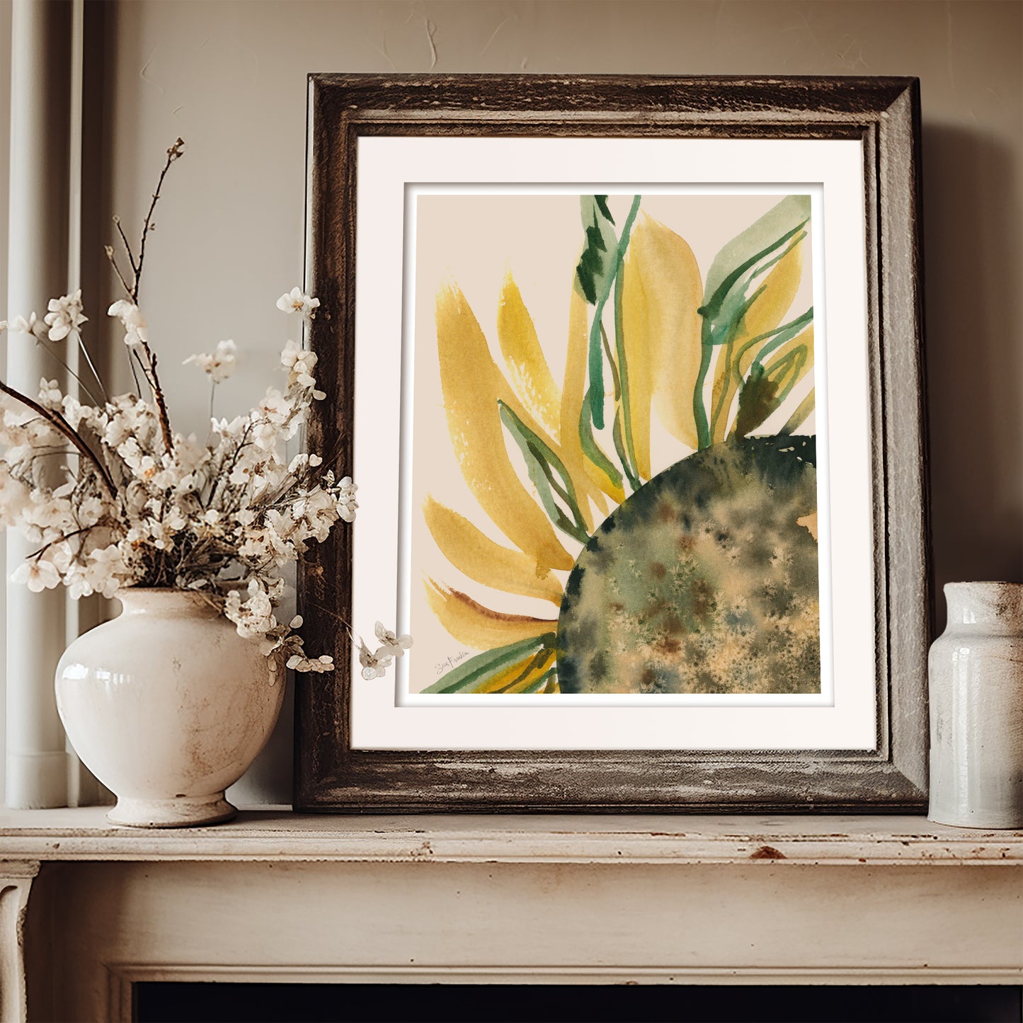 a framed painting of a yellow flower with green leaves, placed on a shelf next to a white vase filled with white flowers.