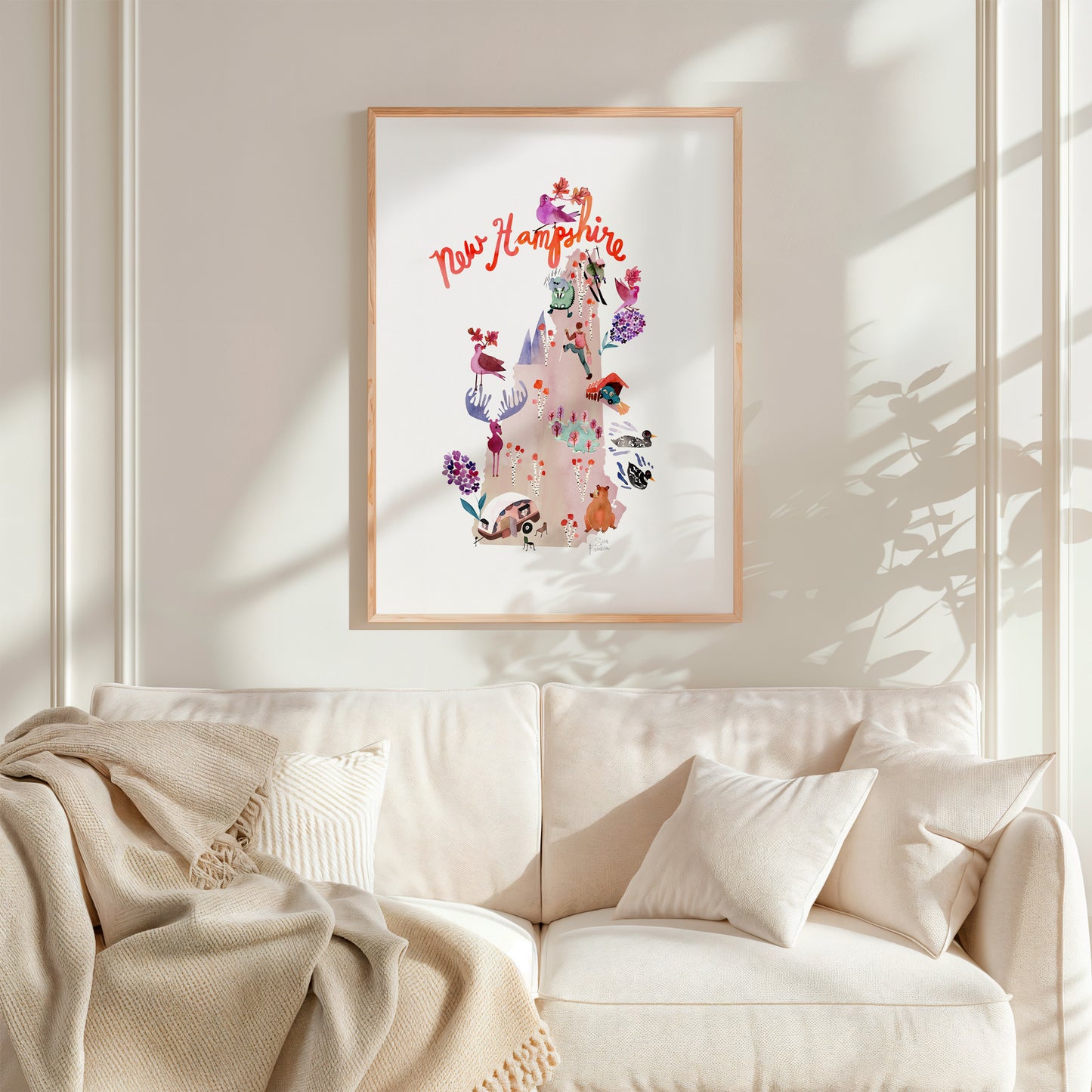 a living room with a white couch and a framed picture