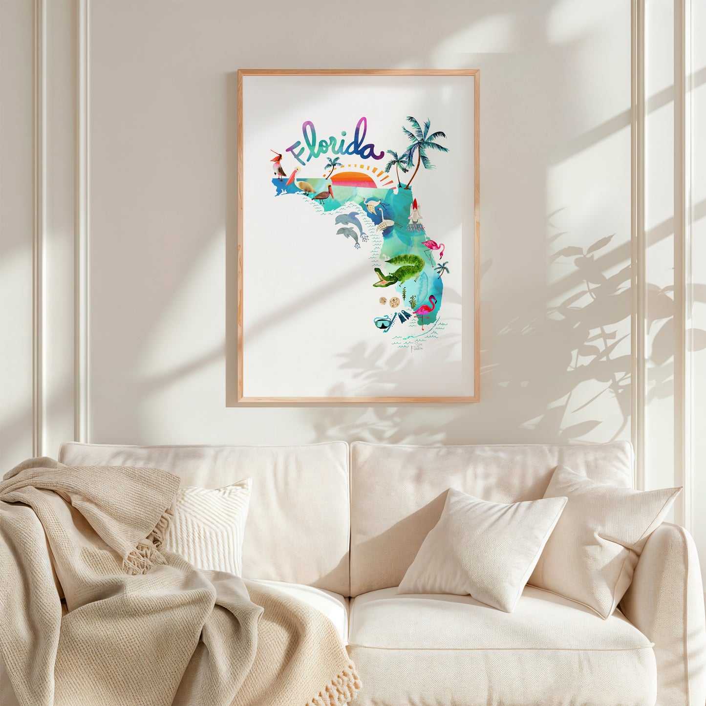 a living room with a white couch and a framed picture