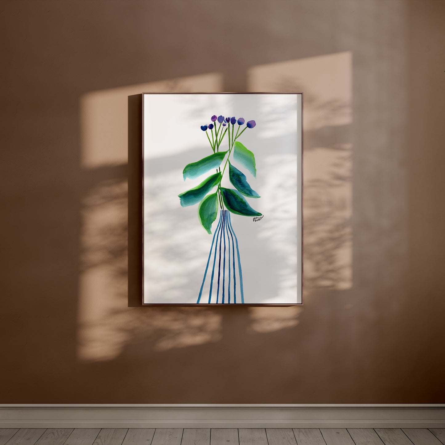 a picture hanging on a wall with a plant in it