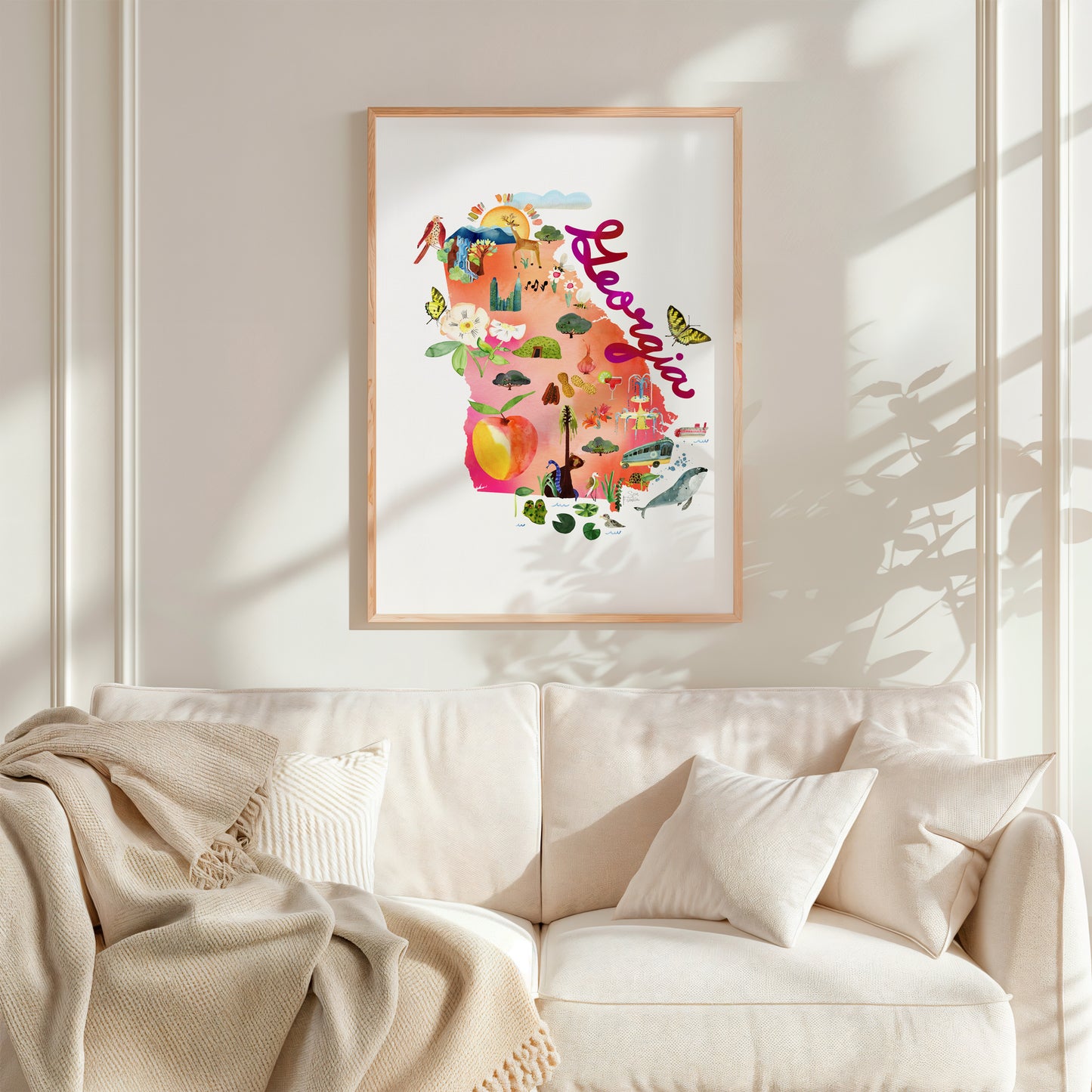 a living room with a white couch and a painting on the wall