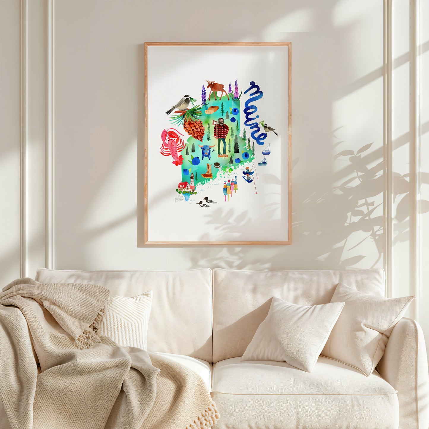a living room with a white couch and a painting on the wall