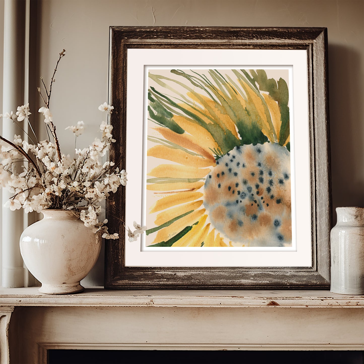 a framed watercolor painting of a sunflower, placed on a shelf next to a white vase filled with white flowers.