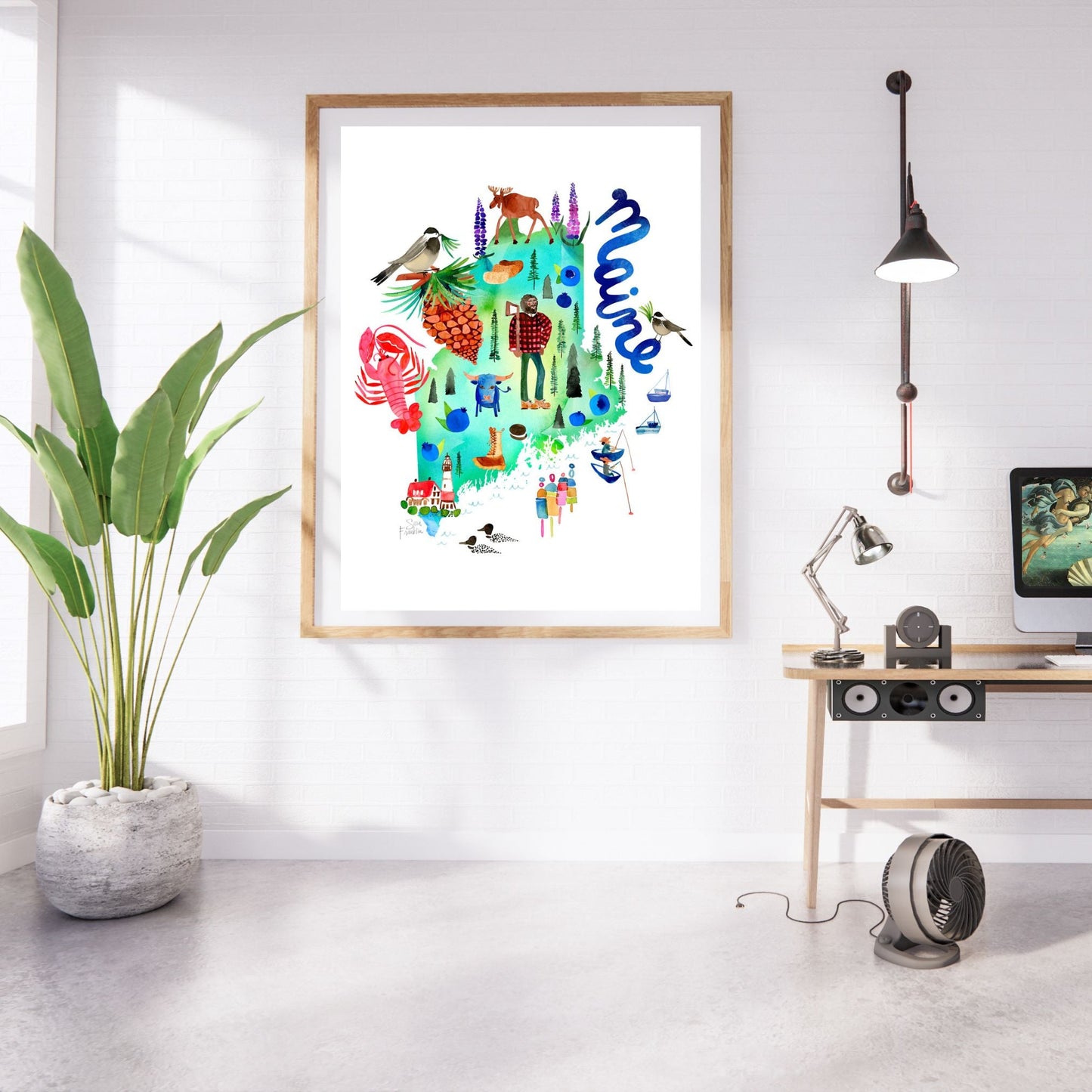 a picture hanging on a wall next to a potted plant