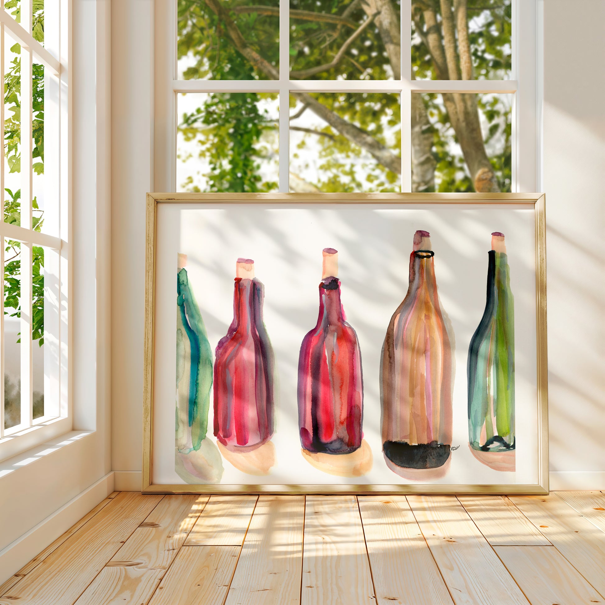 a framed painting of five colorful bottles of wine, each with a unique design and color, displayed on a wooden floor in front of a window with trees visible outside.