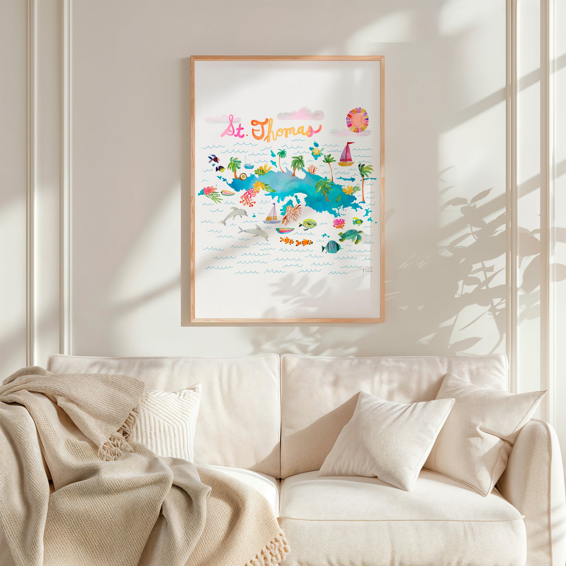 a living room with a white couch and a white blanket