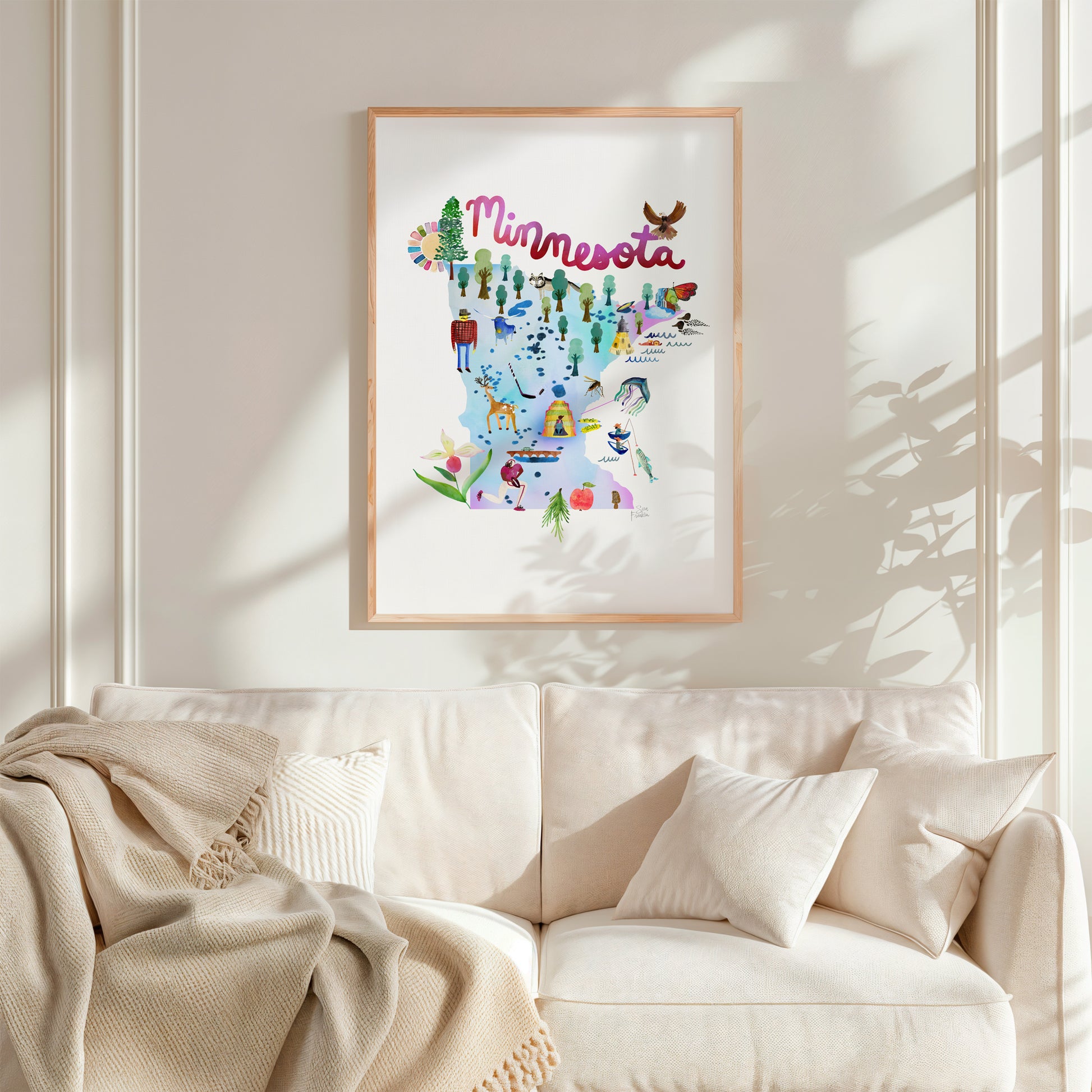 a living room with a white couch and a framed picture