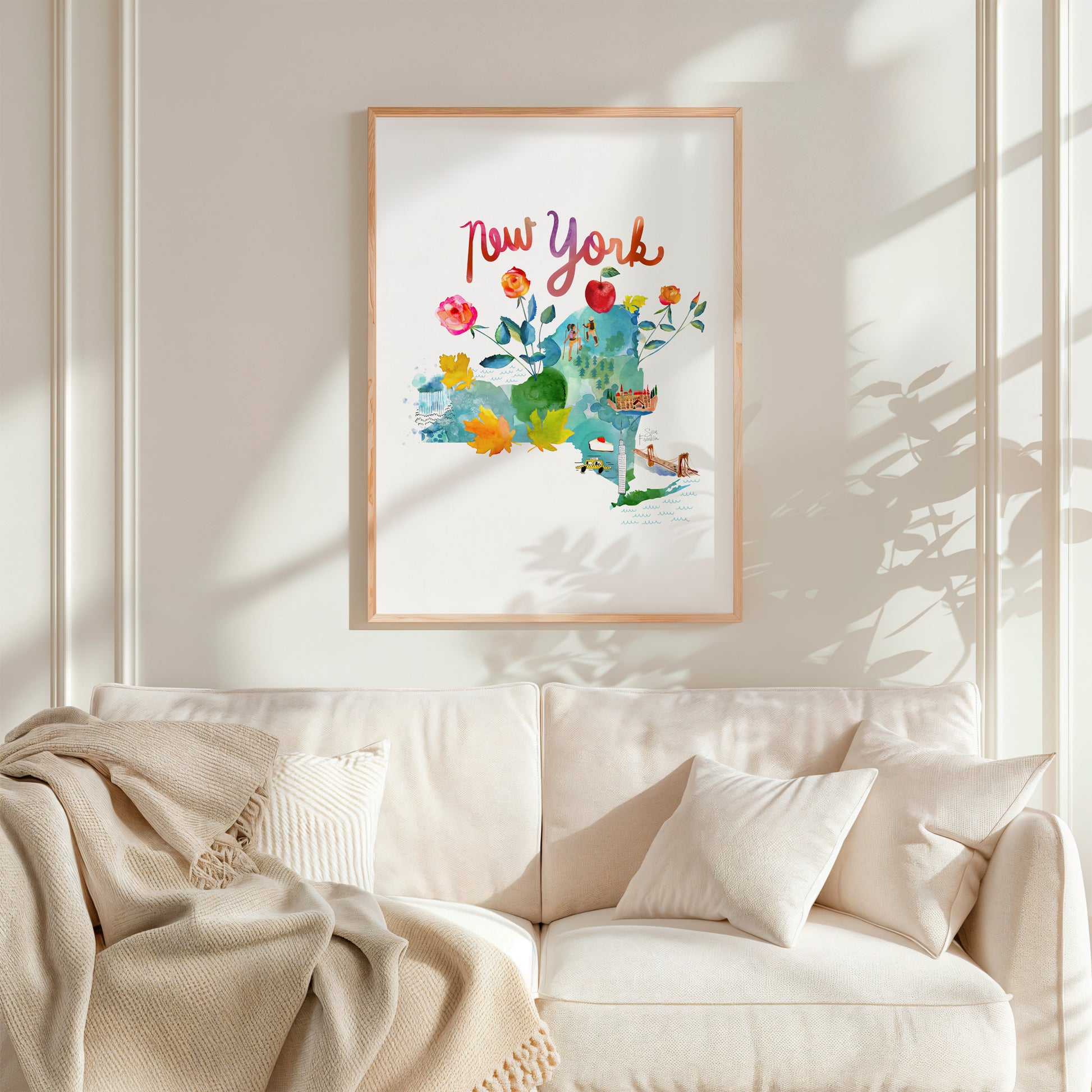 a living room with a white couch and a painting on the wall