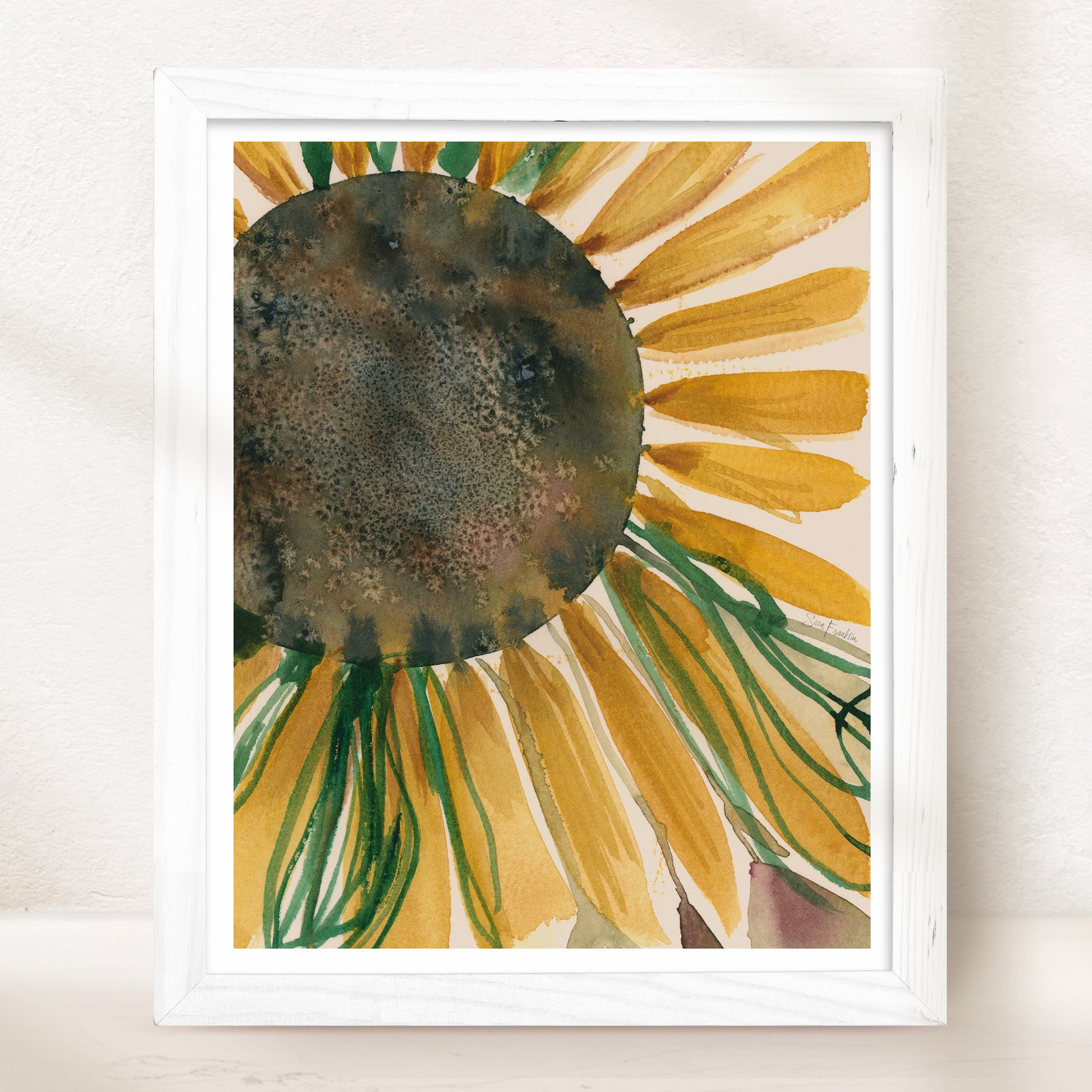 The image is a framed watercolor painting depicting a vibrant sunflower with yellow petals and green stems.