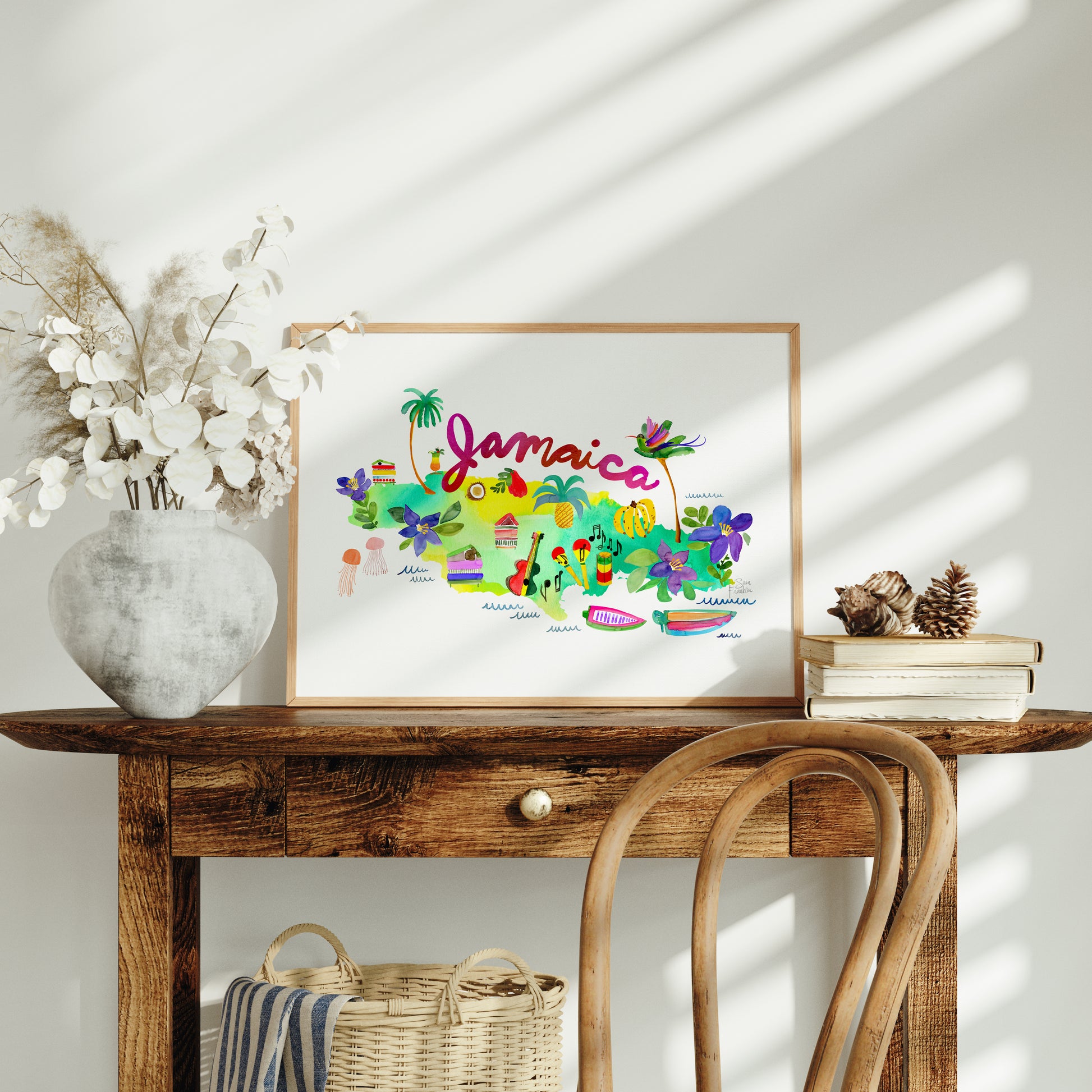 a wooden table with a vase of flowers and a picture on it