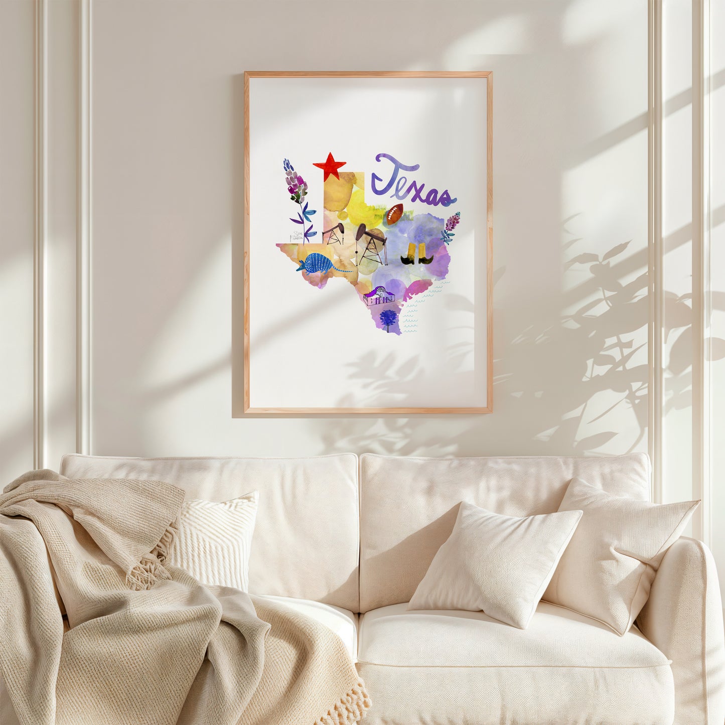 a living room with a white couch and a painting on the wall
