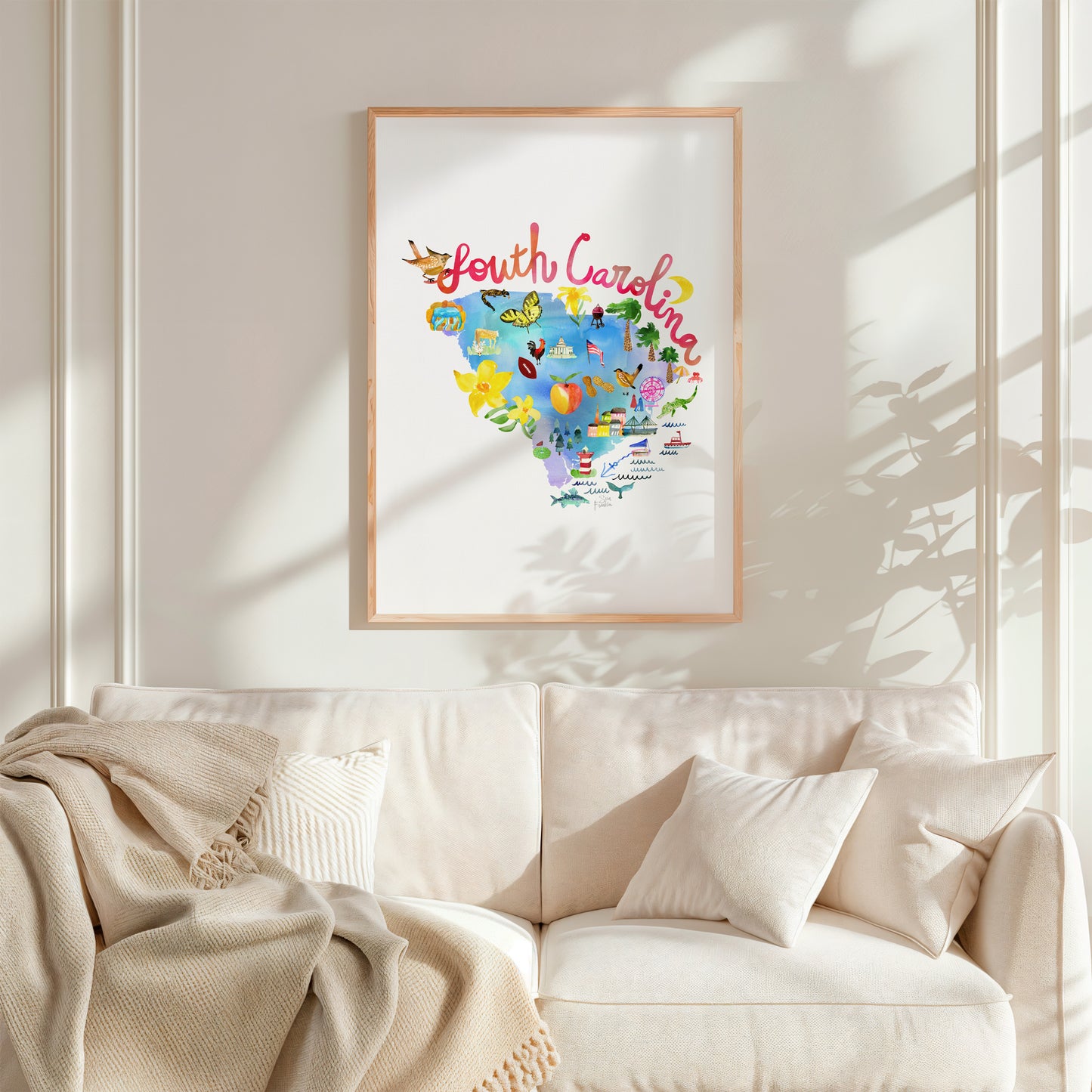 a living room with a white couch and a framed picture