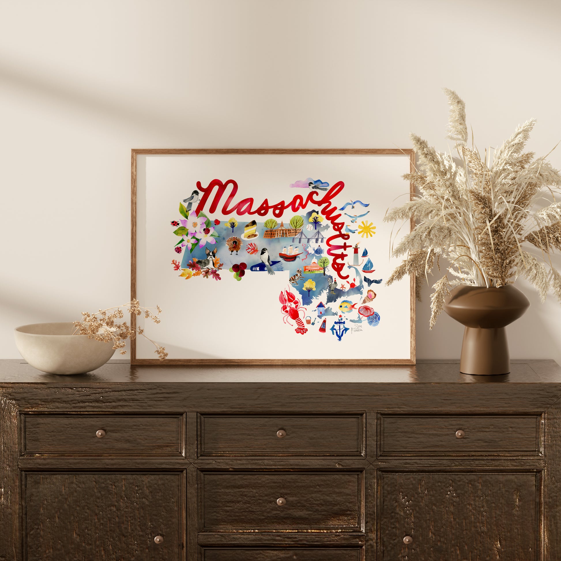 a picture of a vase with a plant on top of a dresser