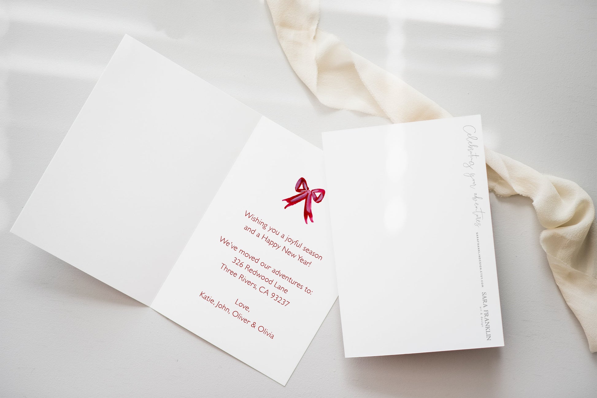 a white card with a red bow on it