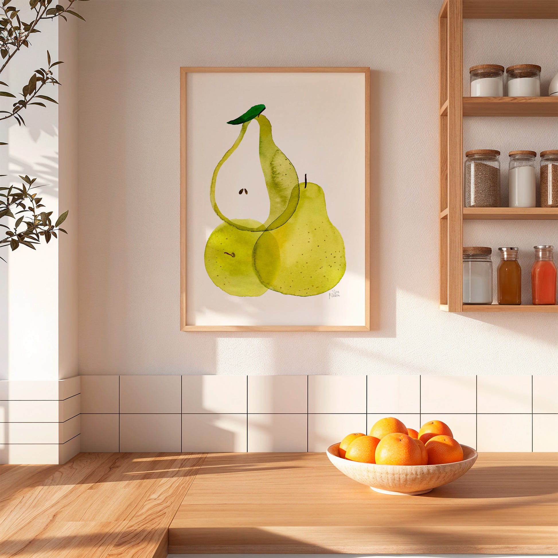 a kitchen scene with a framed painting of two green pears hanging on the wall above a wooden table. On the table, there is a bowl of oranges.