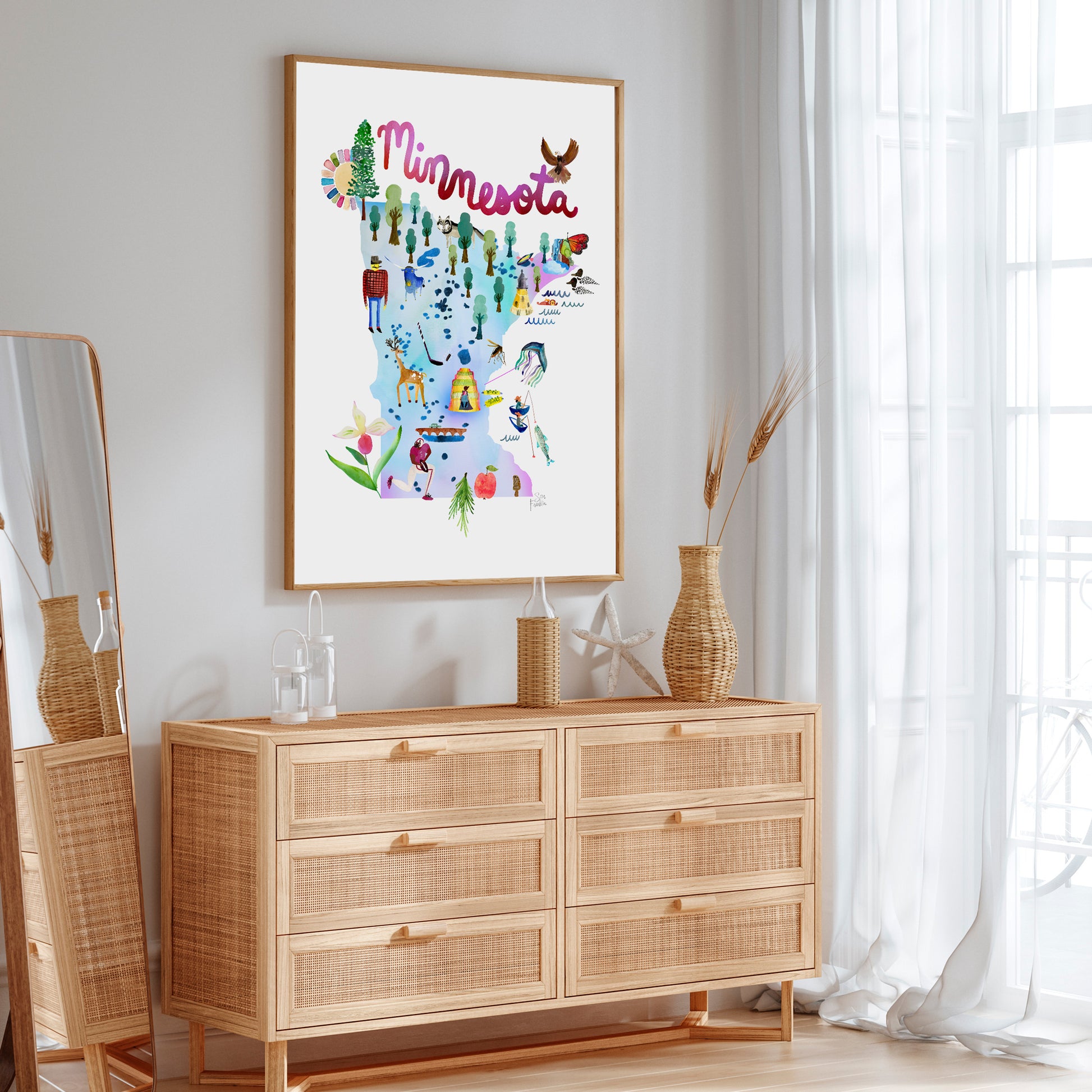 a picture of minnesota hanging on a wall above a dresser