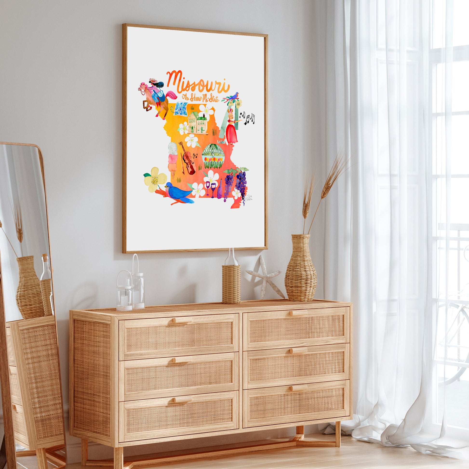 a picture hanging on a wall above a dresser